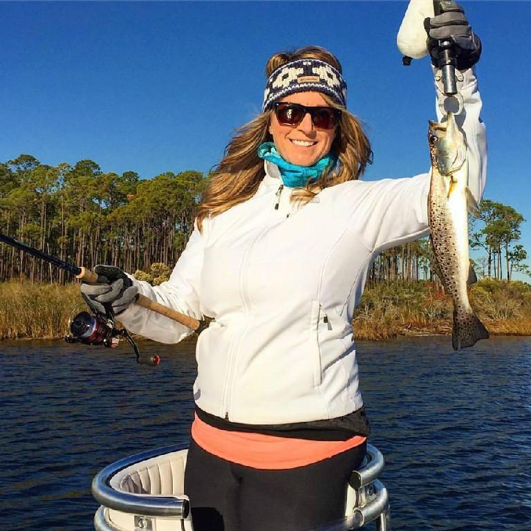 woman holding a caught fish