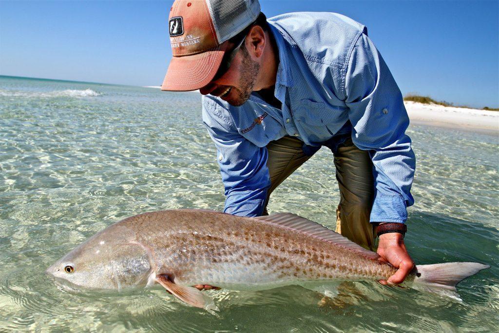 man holding fish in water