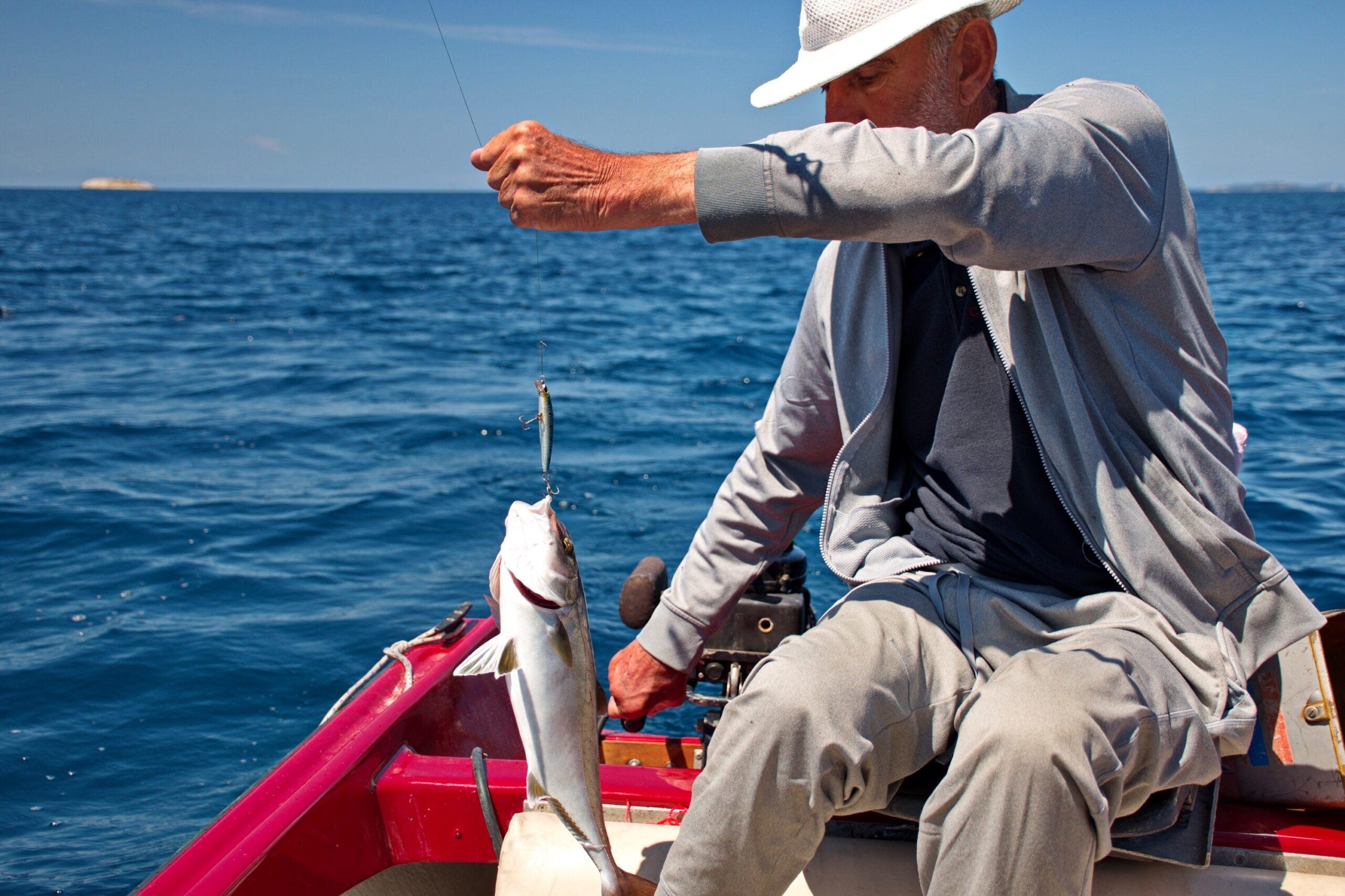 man holding up caught fish